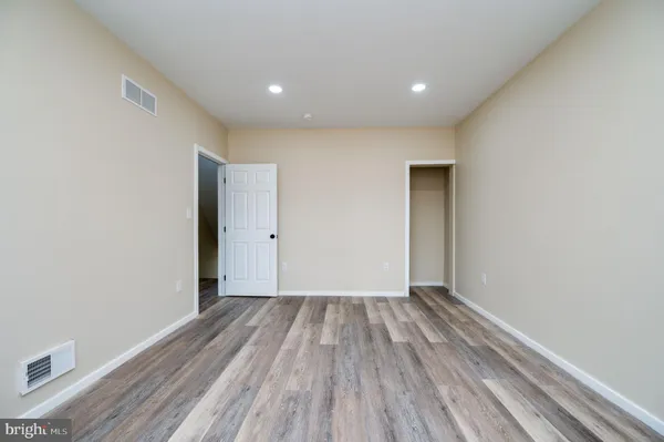 a view of room with wooden floor