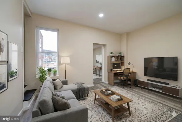 a living room with furniture and a flat screen tv