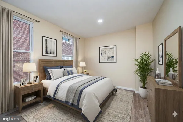 a bedroom with a large bed and a potted plant