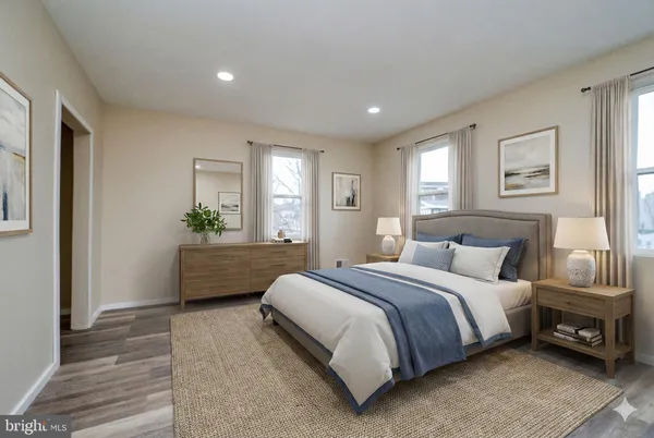 a bedroom with a bed a couch and a window