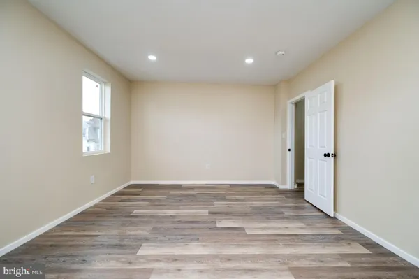 a view of room with window and hardwood floor