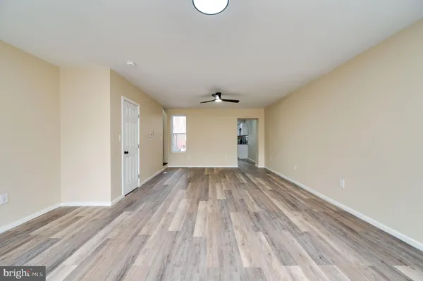 a view of a room with wooden floor and window