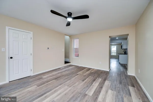 a view of empty room with wooden floor