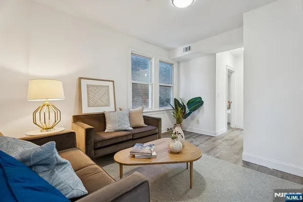 a living room with furniture potted plant and a window