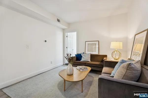 a living room with furniture and a mirror