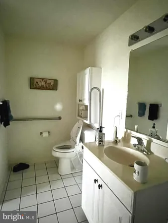 a bathroom with a double vanity sink mirror and toilet