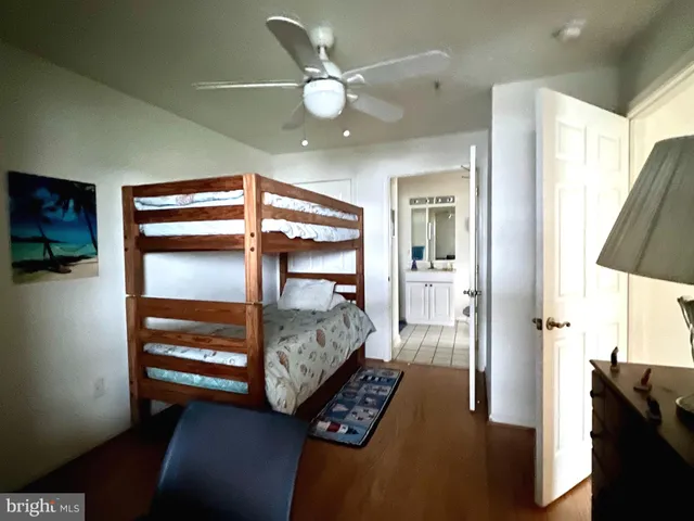 a bedroom with a bed and a glass walk in closet