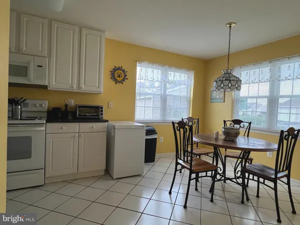 a view of a dining room with furniture and windows