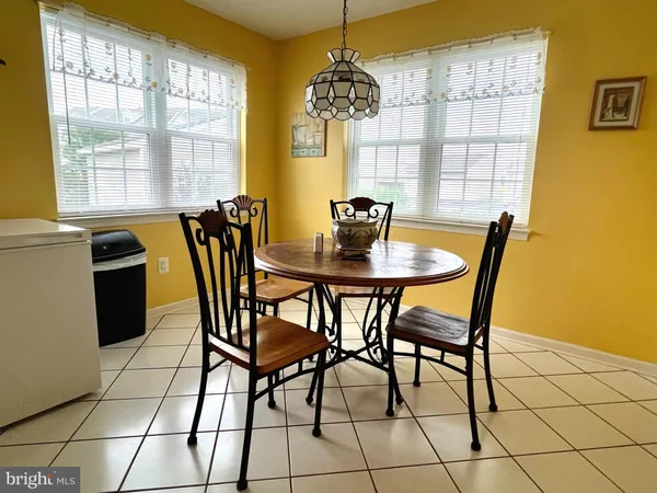 a view of a dining room with furniture and a chandelier