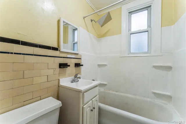 a bathroom with a bathtub a sink and a toilet