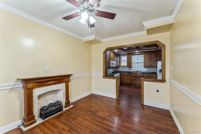 a living room with furniture and a fireplace with wooden floor