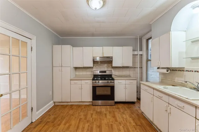 a kitchen with a stove a sink and a refrigerator
