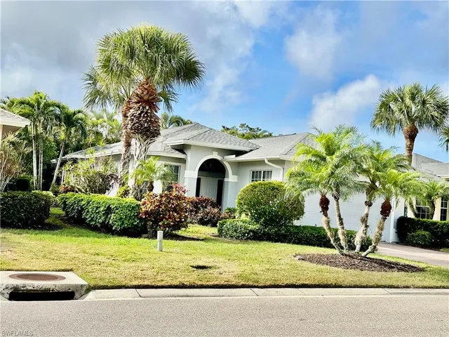 a front view of a house with a yard garage and outdoor seating