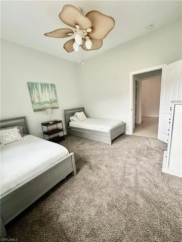 a bedroom with furniture and a large window