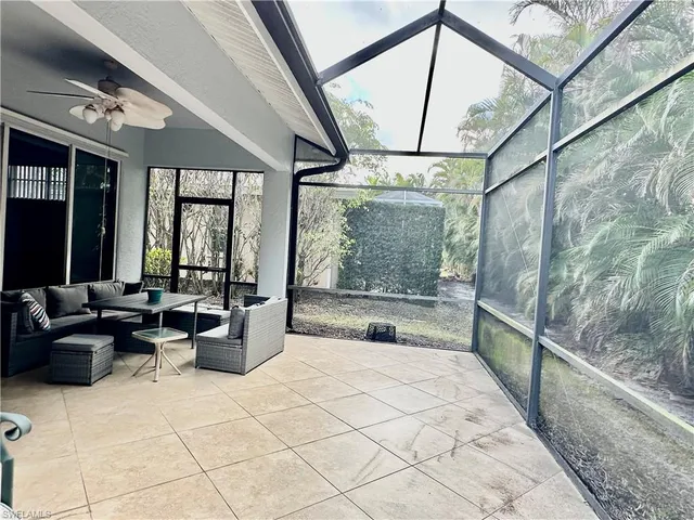 a view of a swimming pool with lawn chairs under an umbrella
