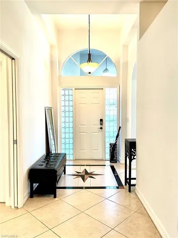 a living room with a furniture and a floor to ceiling window