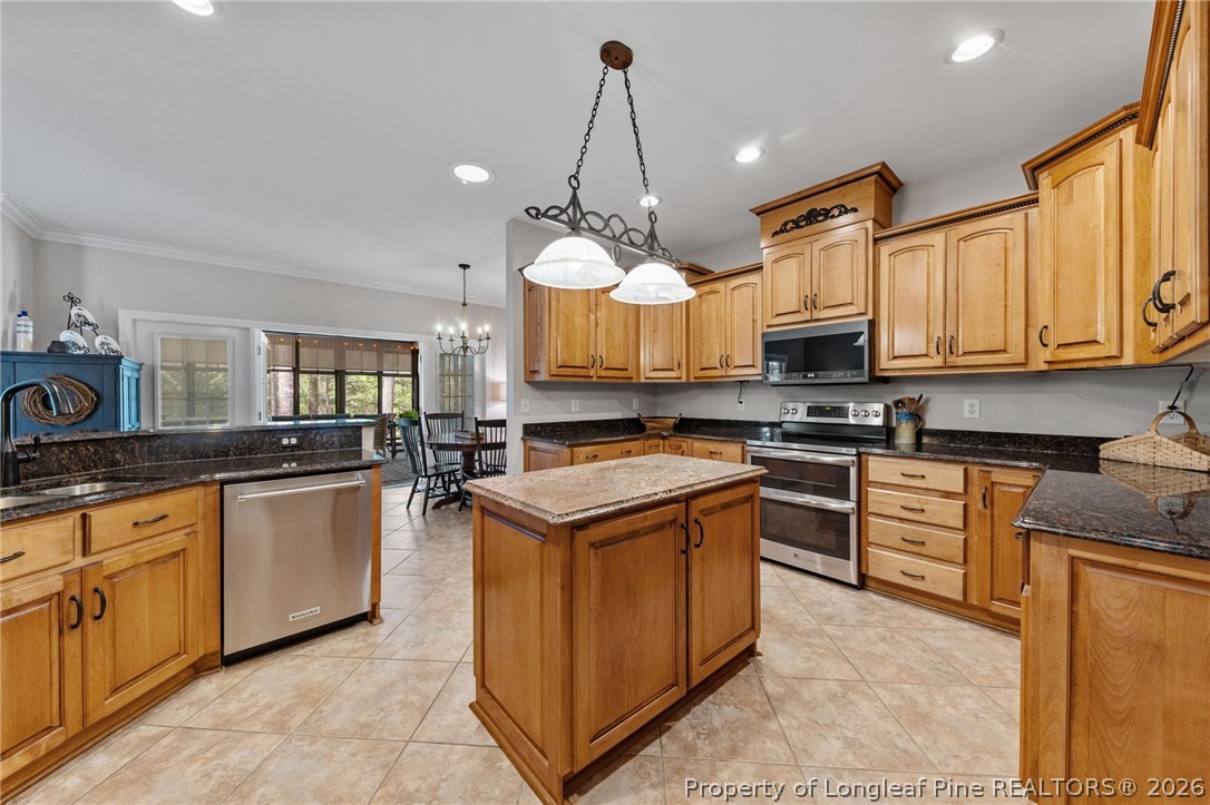 30180 East Lake Road Wagram, NC 28396 - Photo 15 of 42 a kitchen with kitchen island granite countertop a stove oven and a white cabinets