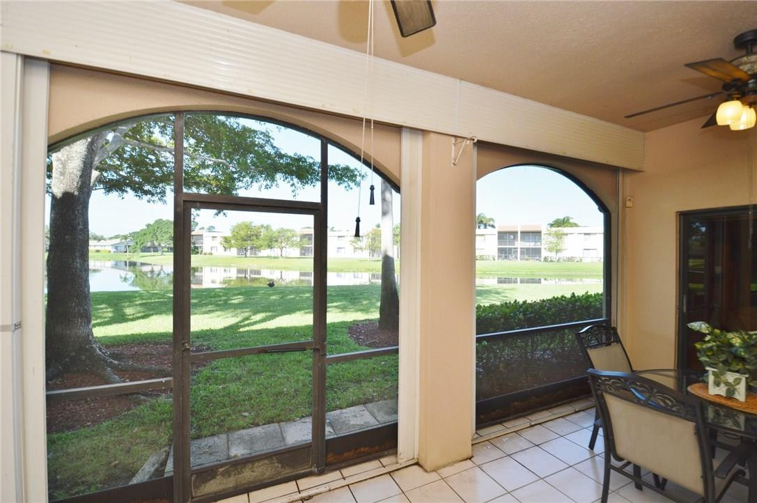 573 Racquet Club Road, Unit 15 Weston, FL 33326 - Photo 3 of 23 a view of a room with a large window and an outdoor view