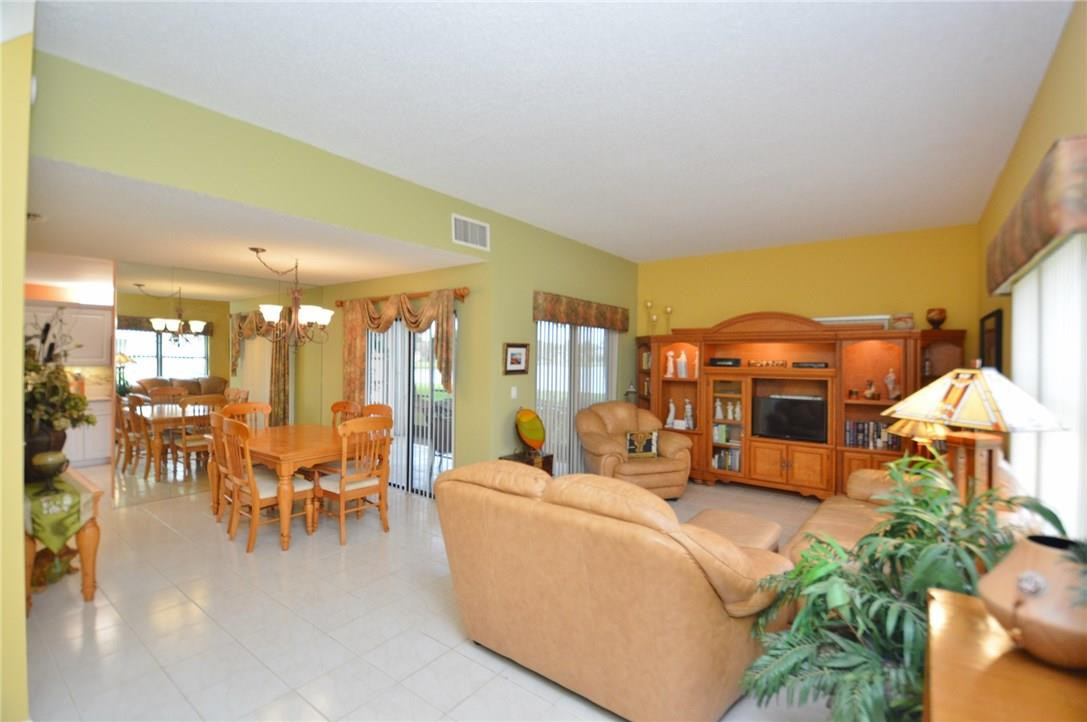 573 Racquet Club Road, Unit 15 Weston, FL 33326 - Photo 6 of 23 a living room with furniture and a large mirror