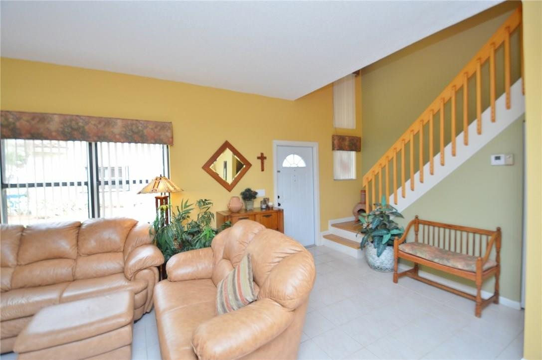 573 Racquet Club Road, Unit 15 Weston, FL 33326 - Photo 8 of 23 a living room with furniture and a large window