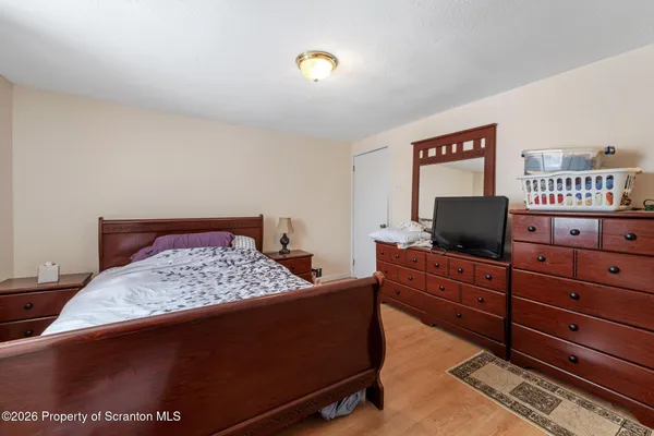 a bedroom with a bed and flat screen tv