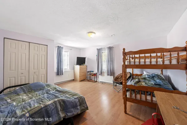 a bedroom with furniture and a large window