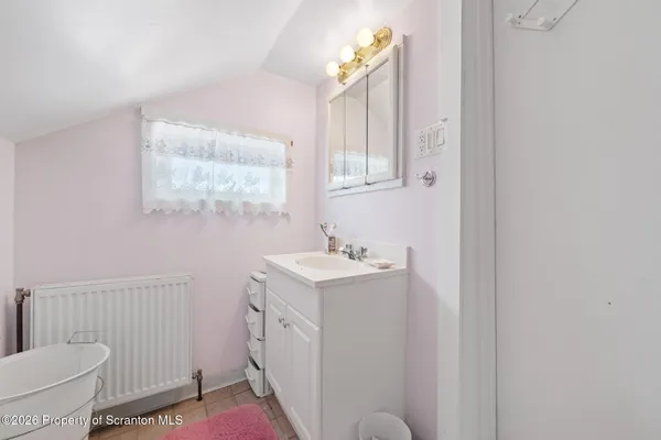 a bathroom with a sink toilet and window