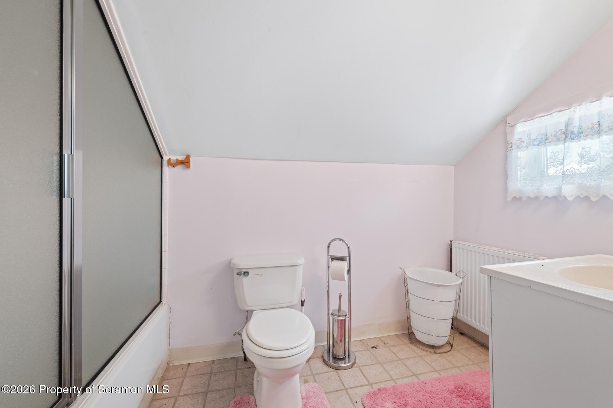 812 Old Street Hazleton, PA 18202 - Photo 19 of 29 a white toilet sitting next to a bathroom sink and vanity