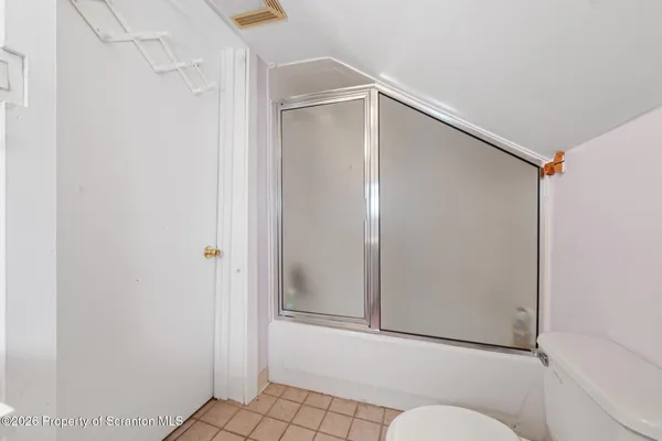 a bathroom with a shower and a toilet