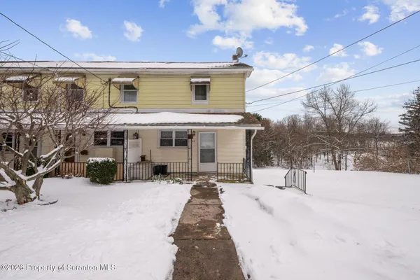 a view of a house with a snow in the yard