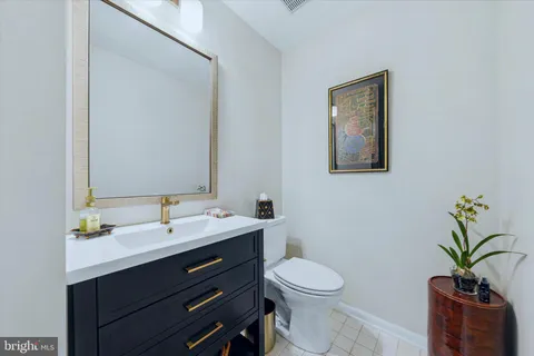 a bathroom with a toilet a sink and a mirror