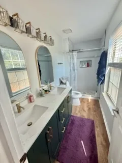 a bathroom with double vanity sink and a mirror