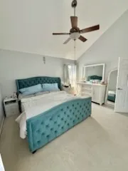 a bedroom with a bed and ceiling fan