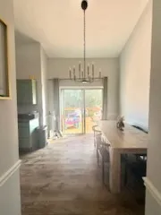 a room with pool table and windows