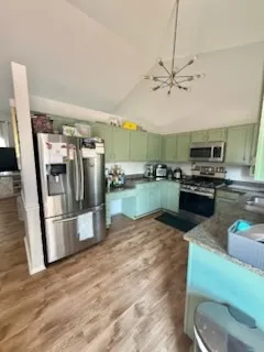 a kitchen with stainless steel appliances granite countertop a refrigerator and a sink