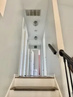 a view of staircase with white walls