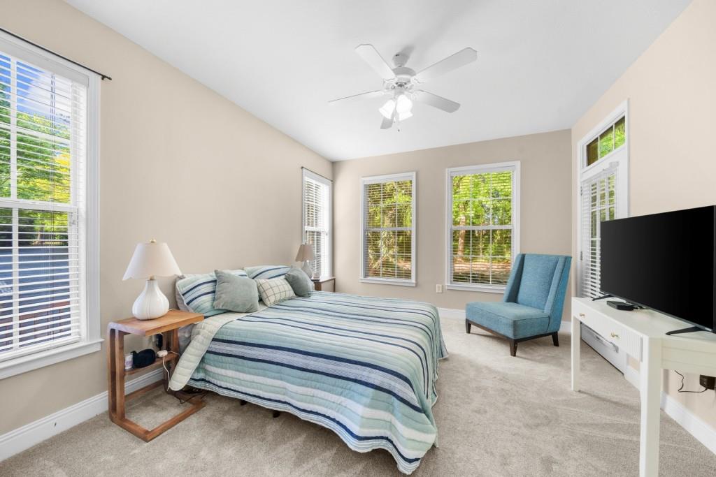 2103 Stratford Commons, Unit 2103 Decatur, GA 30033 - Photo 14 of 32 a spacious bedroom with a bed and a flat screen tv