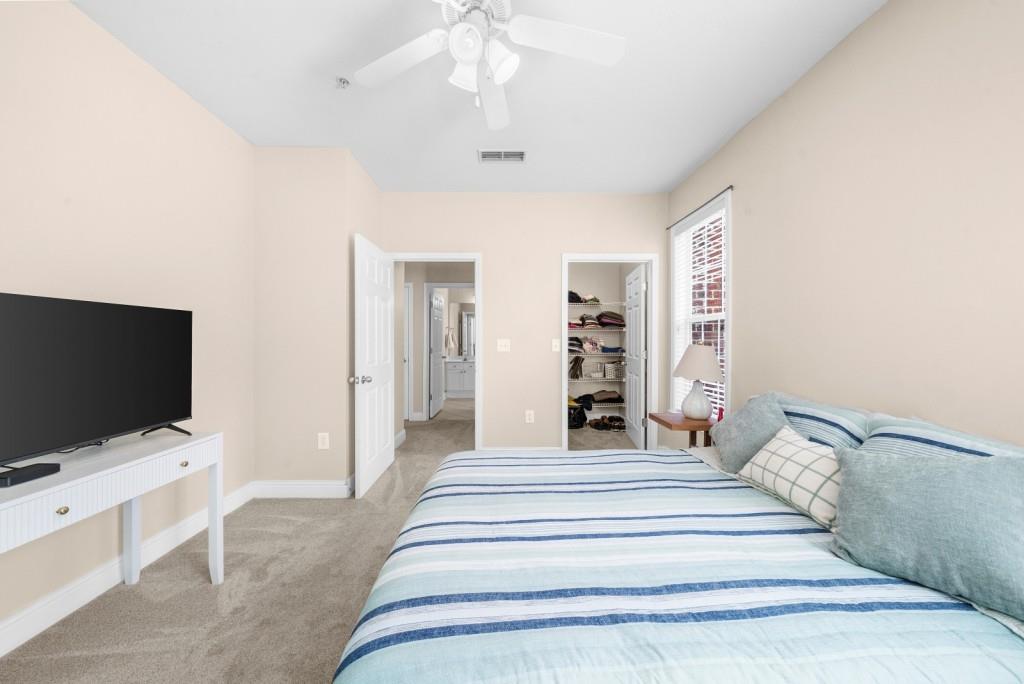 2103 Stratford Commons, Unit 2103 Decatur, GA 30033 - Photo 15 of 32 a spacious bedroom with a bed and a flat screen tv