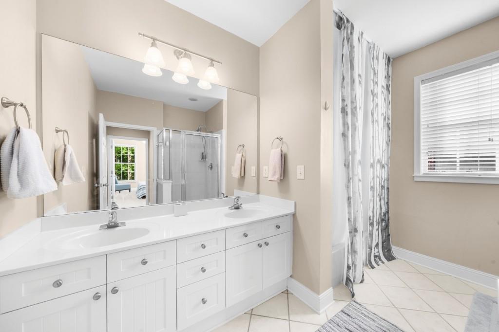 2103 Stratford Commons, Unit 2103 Decatur, GA 30033 - Photo 17 of 32 a bathroom with a shower sink and mirror