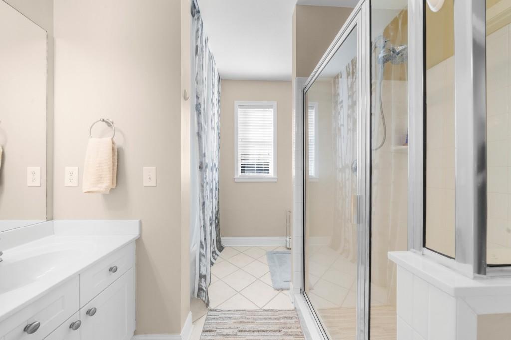 2103 Stratford Commons, Unit 2103 Decatur, GA 30033 - Photo 19 of 32 a bathroom with a granite countertop sink and a mirror
