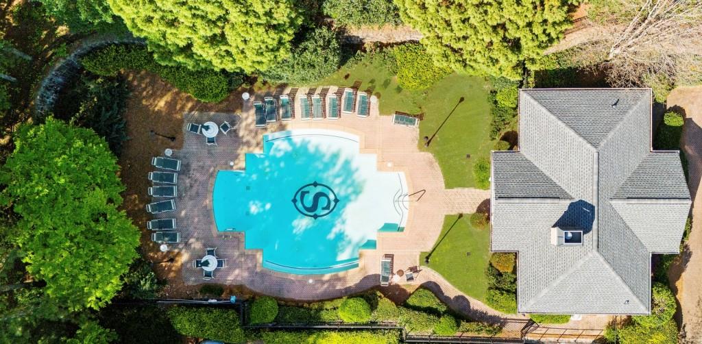 2103 Stratford Commons, Unit 2103 Decatur, GA 30033 - Photo 2 of 32 an aerial view of a house with swimming pool and large trees