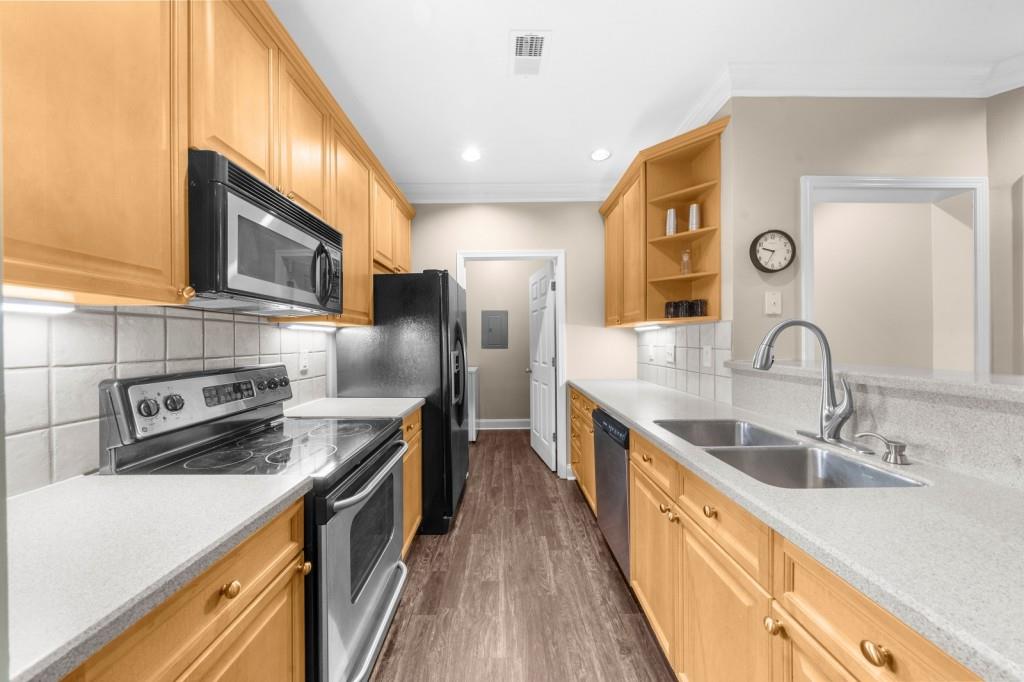 2103 Stratford Commons, Unit 2103 Decatur, GA 30033 - Photo 4 of 32 a kitchen with stainless steel appliances a sink a stove and a refrigerator