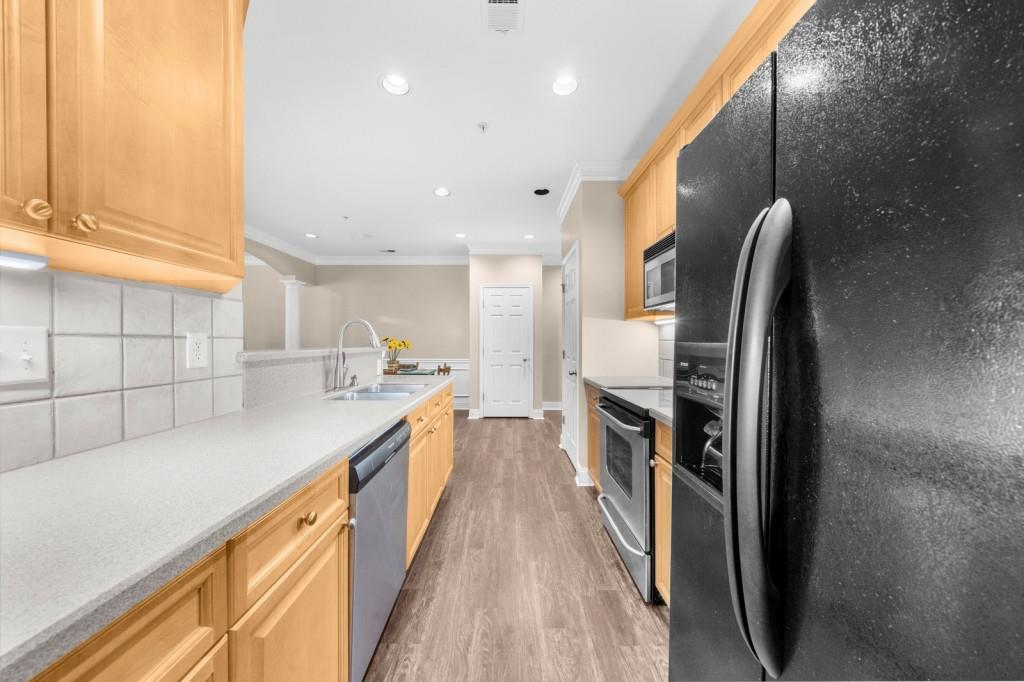 2103 Stratford Commons, Unit 2103 Decatur, GA 30033 - Photo 6 of 32 a kitchen with stainless steel appliances granite countertop a refrigerator and a sink