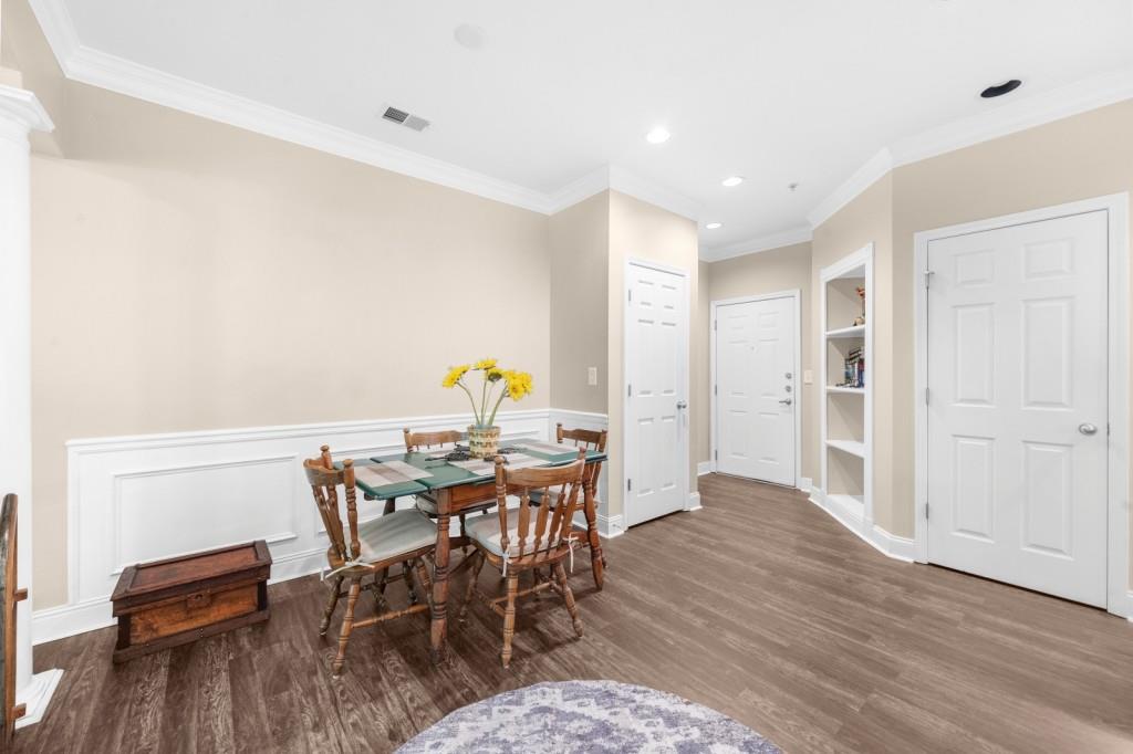 2103 Stratford Commons, Unit 2103 Decatur, GA 30033 - Photo 8 of 32 a view of a dining room with furniture and wooden floor