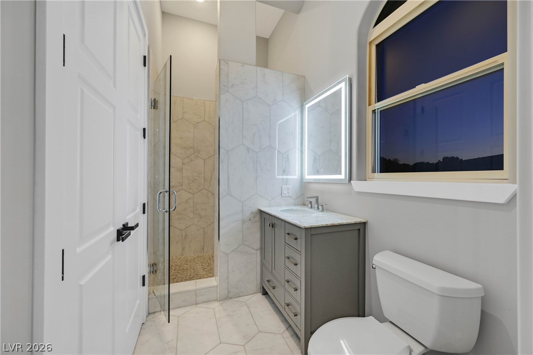 6 Rue Du Ville Henderson, NV 89011 - Photo 69 of 99 This bright bathroom features a modern vanity, a spacious shower, and elegant tilework.