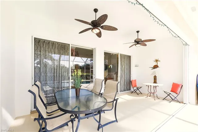 a living room with furniture a fireplace and a large window