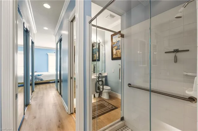 a bathroom with a glass shower door and a glass door shower