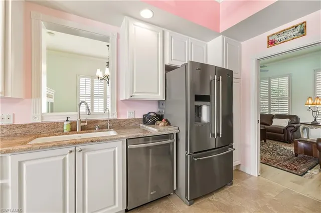 a kitchen with kitchen island granite countertop a sink stainless steel appliances and counter space