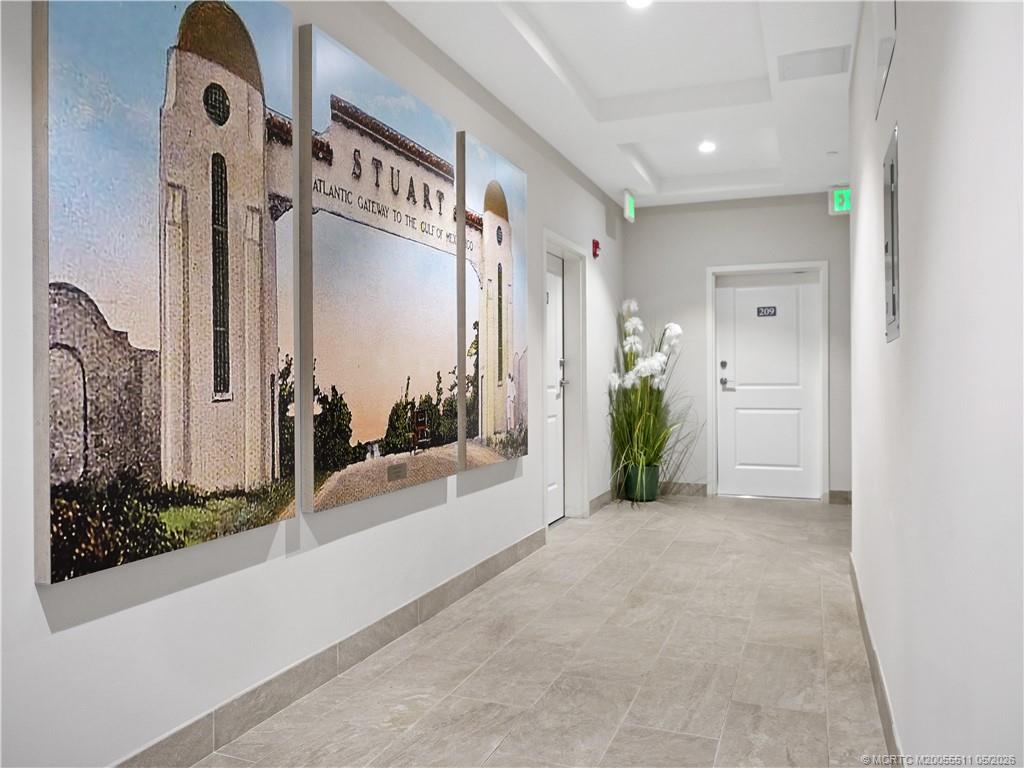 41 Southwest Seminole Street, Unit 208 Stuart, FL 34994 - Photo 42 of 46 a view of a hallway with potted plants in front of door