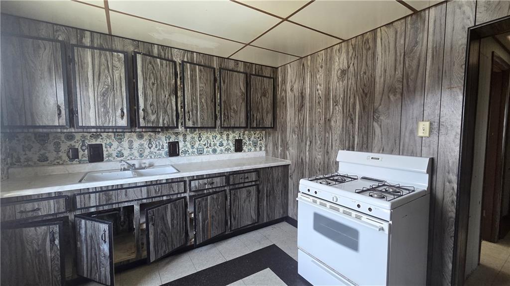122 Hamilton Avenue Vandergrift, PA 15690 - Photo 4 of 13 a kitchen with a sink cabinets and appliances